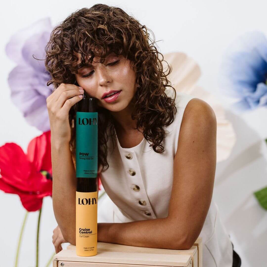 Brunette curly hair girl with curl cream and strong hold curl gel