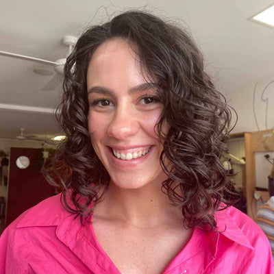 caucasian woman with brunette 2c wavy hair in a bob cut